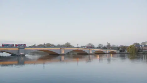 Putney Bridge Over River Thames In London Illuminated In Winter With Buses