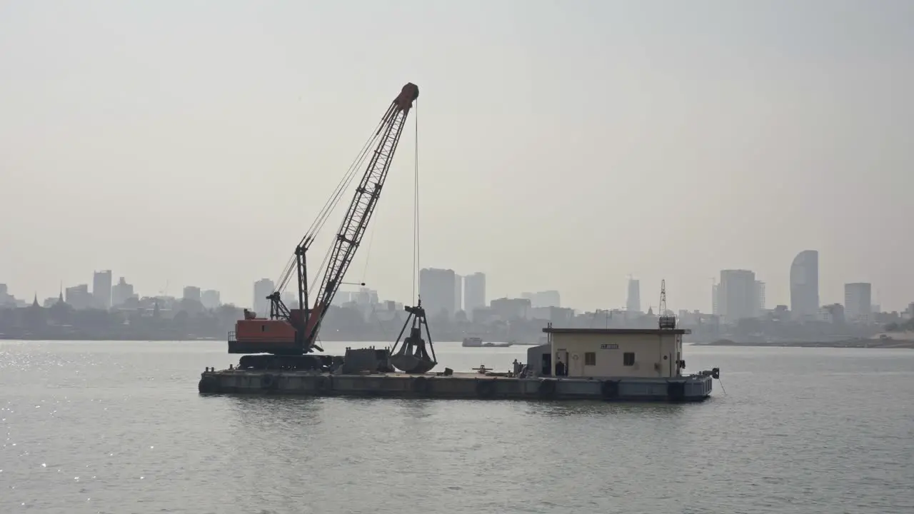 Backhoe on a floating platform Mekong River