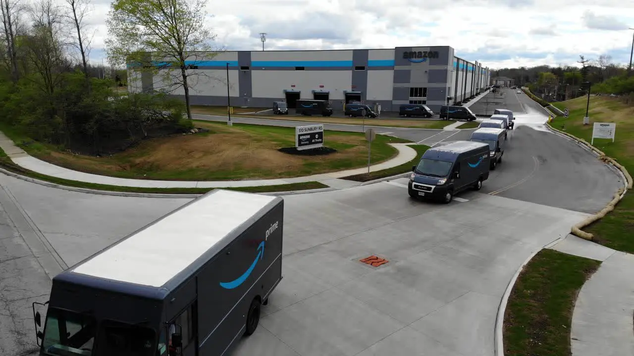 Amazon delivery vans and trucks pull out of an Amazon warehouse on the Eastside of Columbus Ohio