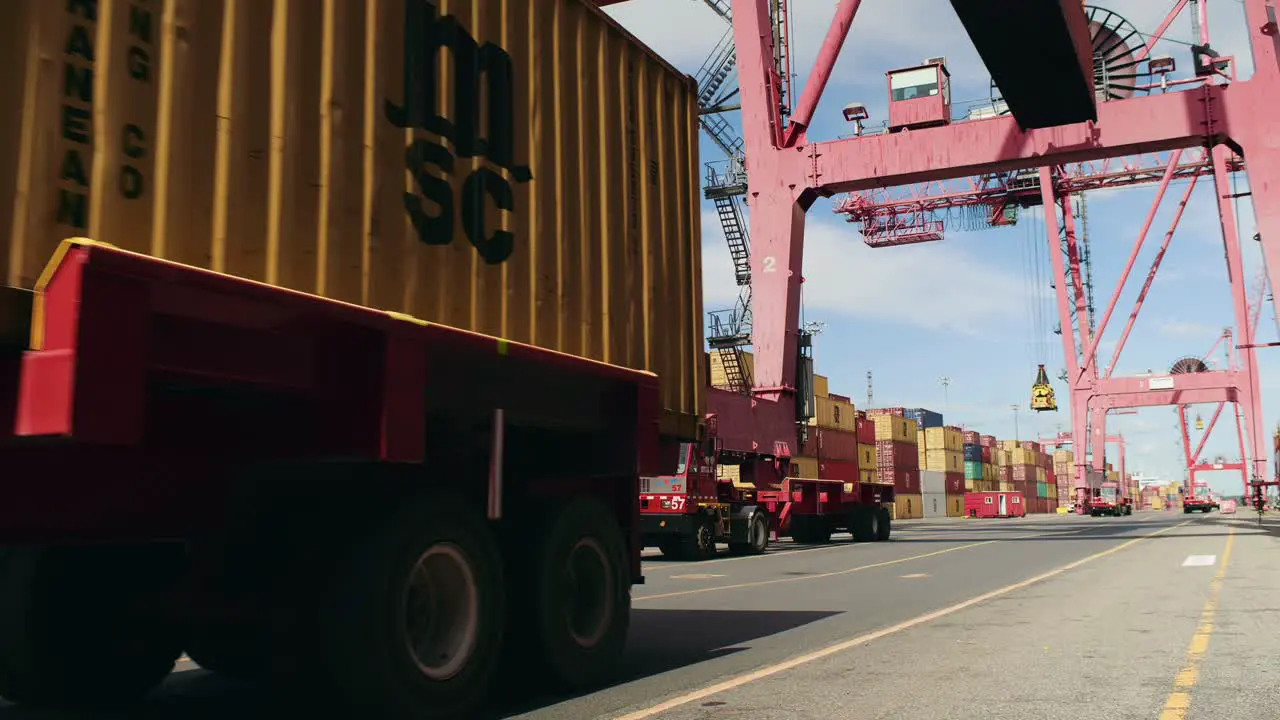 Trailer truck container haulage leaving port of Montreal loading crane terminal