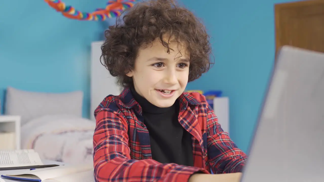 Boy playing games on laptop is excited and experiencing action