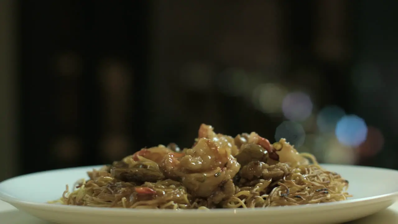 Panning Shot Of A Filipino Style Noodle With Beef and Shrimp Toppings