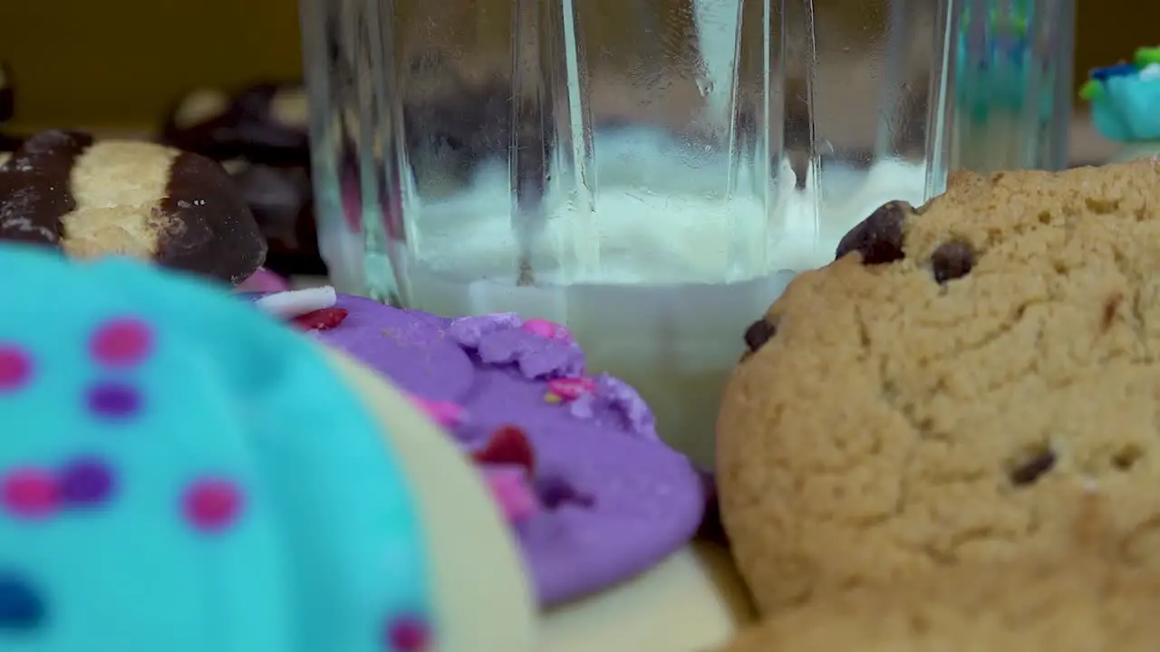 Slow Motion Of Milk Pouring Surrounded By Tasty Cookies