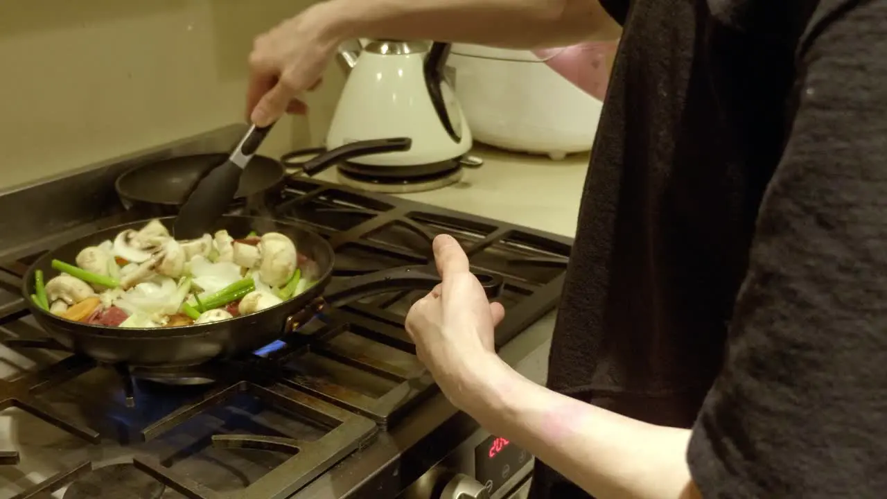 Chef In The Kitchen Cooking Delicious Korean Beef Bulgogi In Pan With Fresh Vegetables And Mushrooms