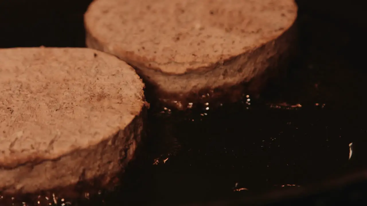 PlantBased Burgers Cooking in Hot Pan with Oil Bubbling