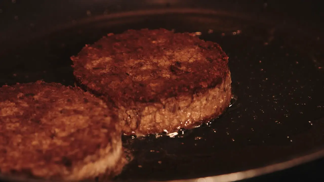 PlantBased Burgers Gently Frying in Hot Frying Pan