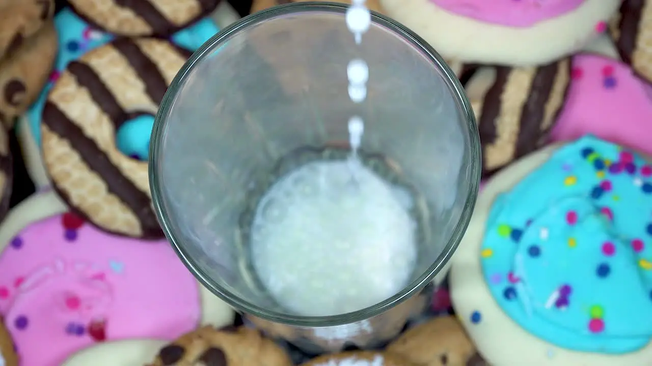 Milk Pouring Into Glass With Cookies Slow Motion