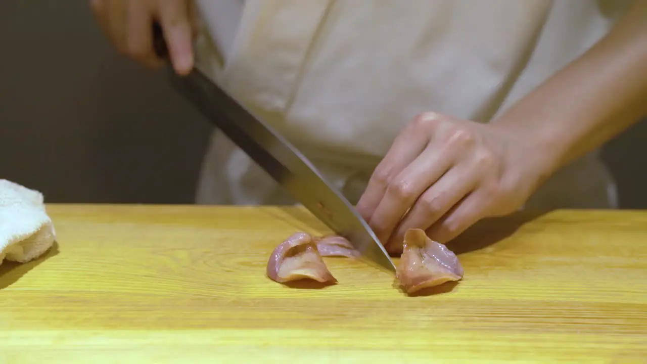 Chef Cutting Fresh Meat For Sushi In A Chinese Restaurant In Guangzhou China close up