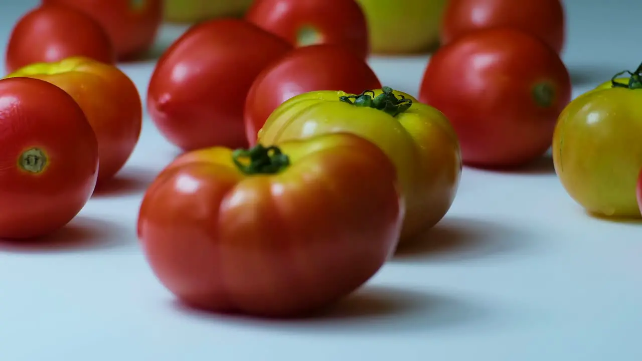 Variety of Red and Yellow Tomatoes Placed on a White Surface