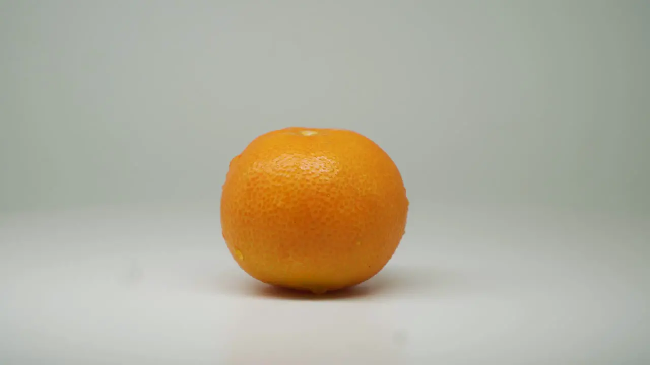 Fresh Orange Fruit On The Rotating Table With White Plain Background Close Up Shot