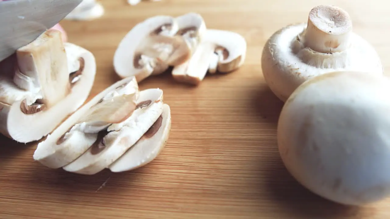 Chopping mushroom on a wooden cutting board