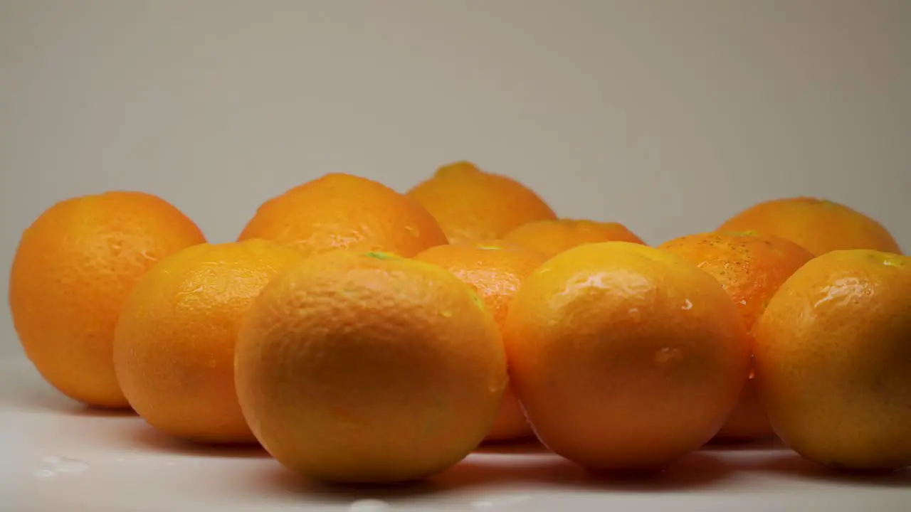 Group Of Fresh Juicy Orange On The Turntable With White Background Close Up Shot