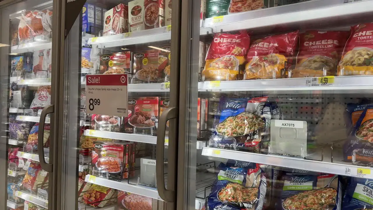 Frozen bagged family sized meals food in grocery store aisle section on sale