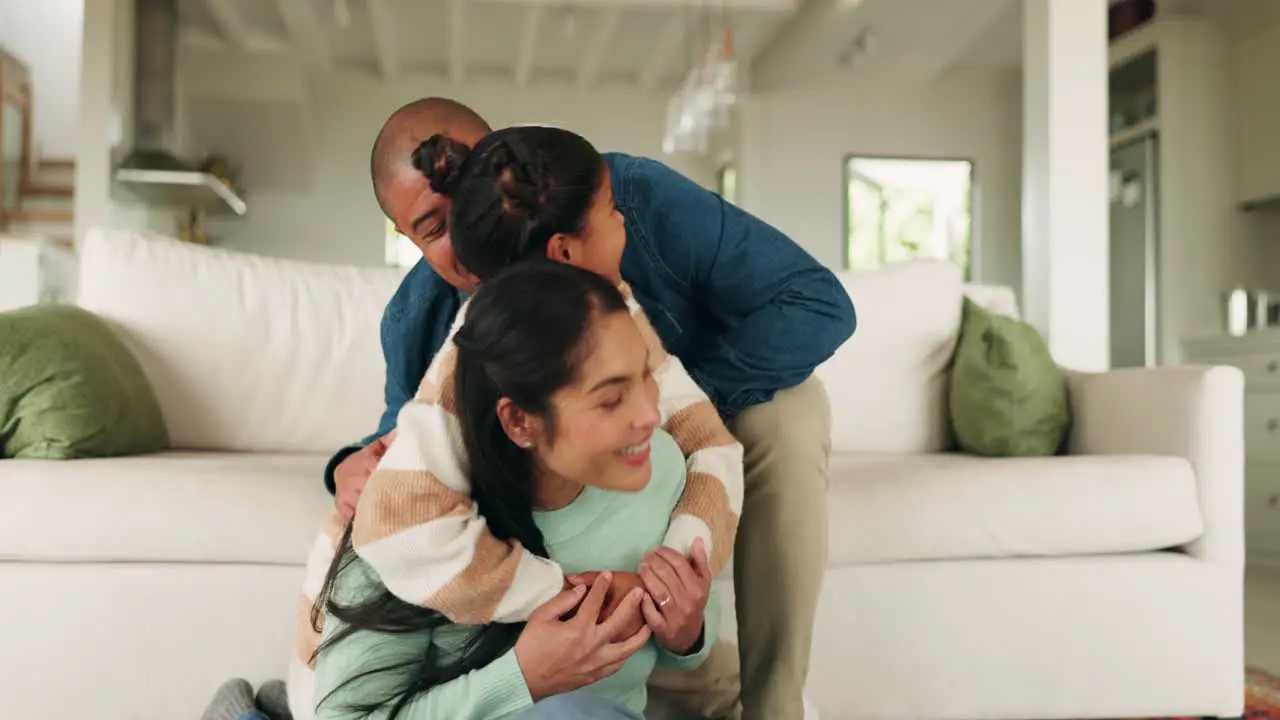 Mother father and girl hug on sofa for bonding