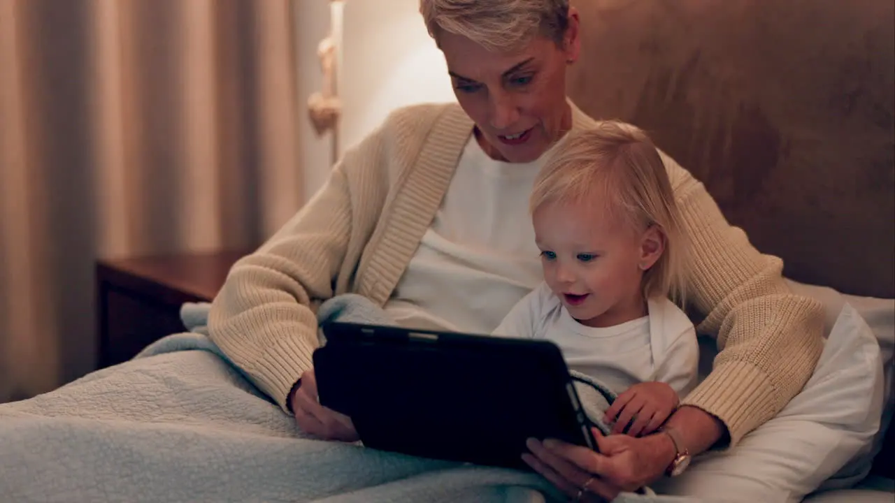 Woman baby and child relax with tablet in bedroom