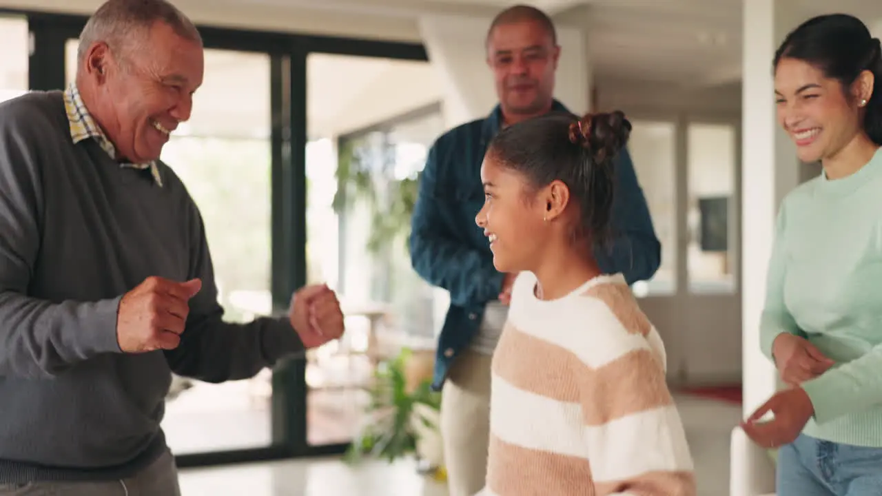 Family home dancing and a child celebrate