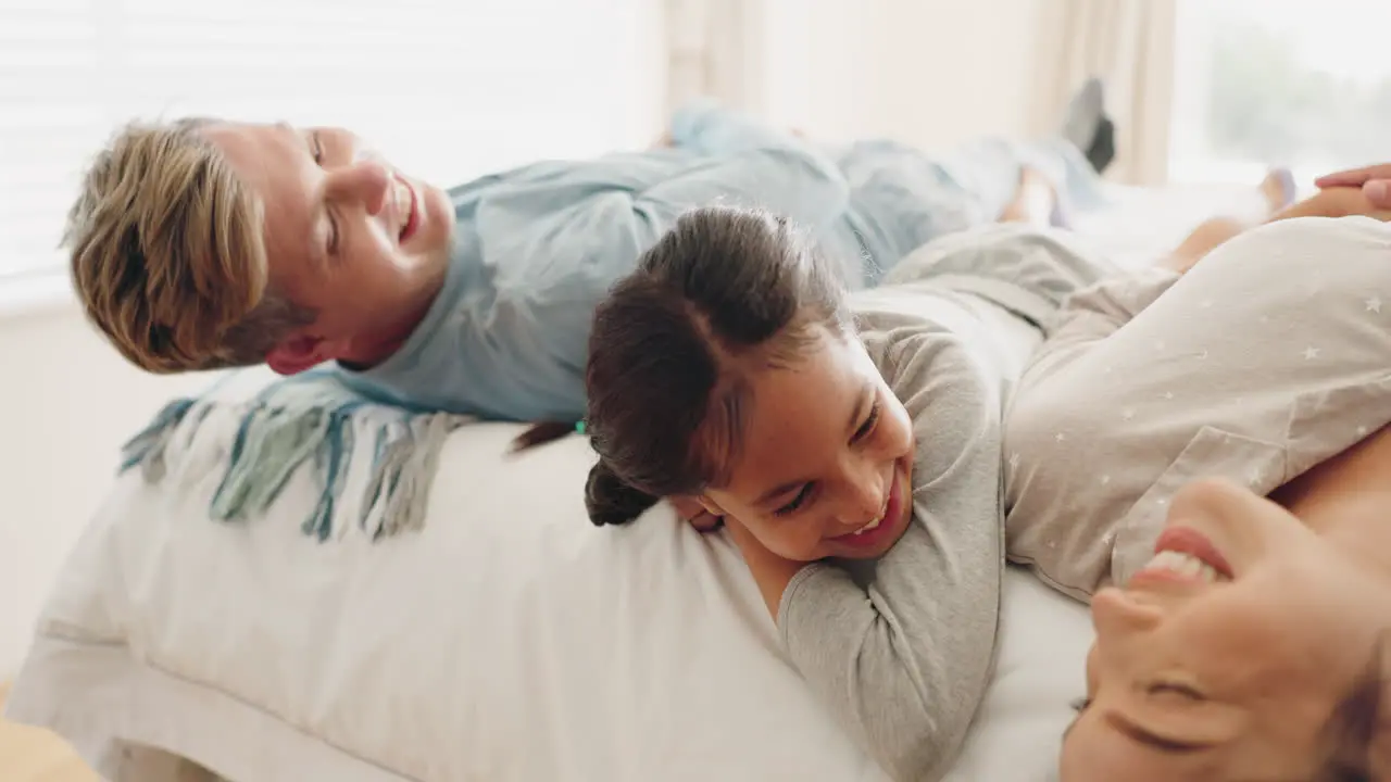 Happy family bed and child playing in a bedroom