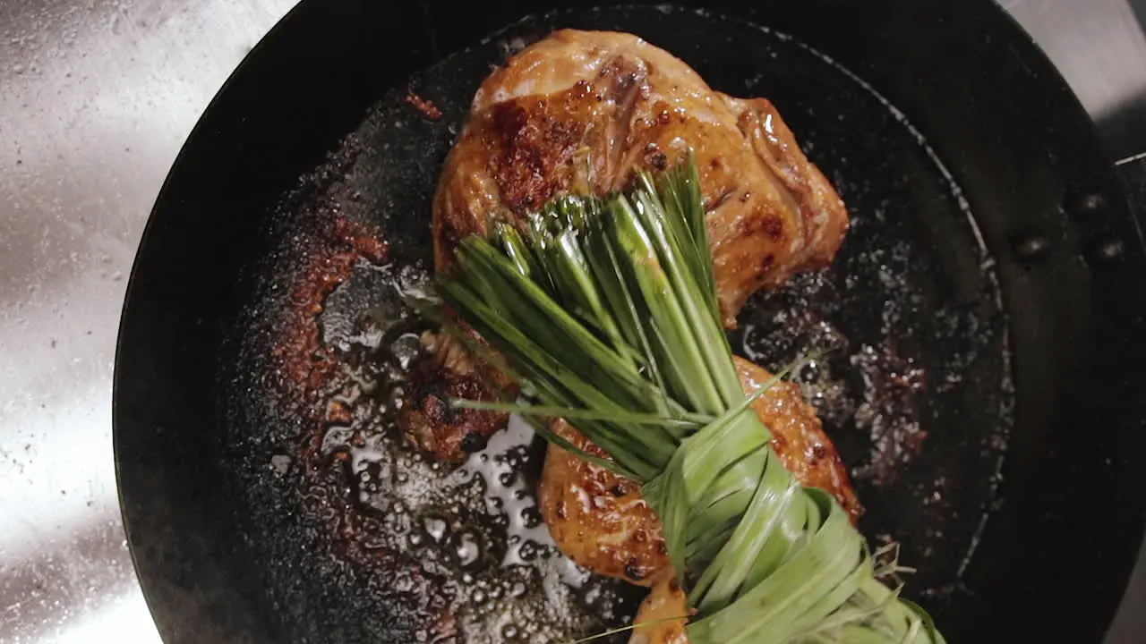 Oil Dabbing Chicken Thighs With Lemongrass While Cooking In A Pan