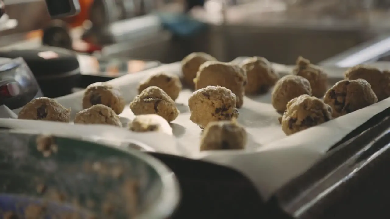 Rolled Cookie Dough In A Tray With Wax Paper Ready For Baking selective focus slider right