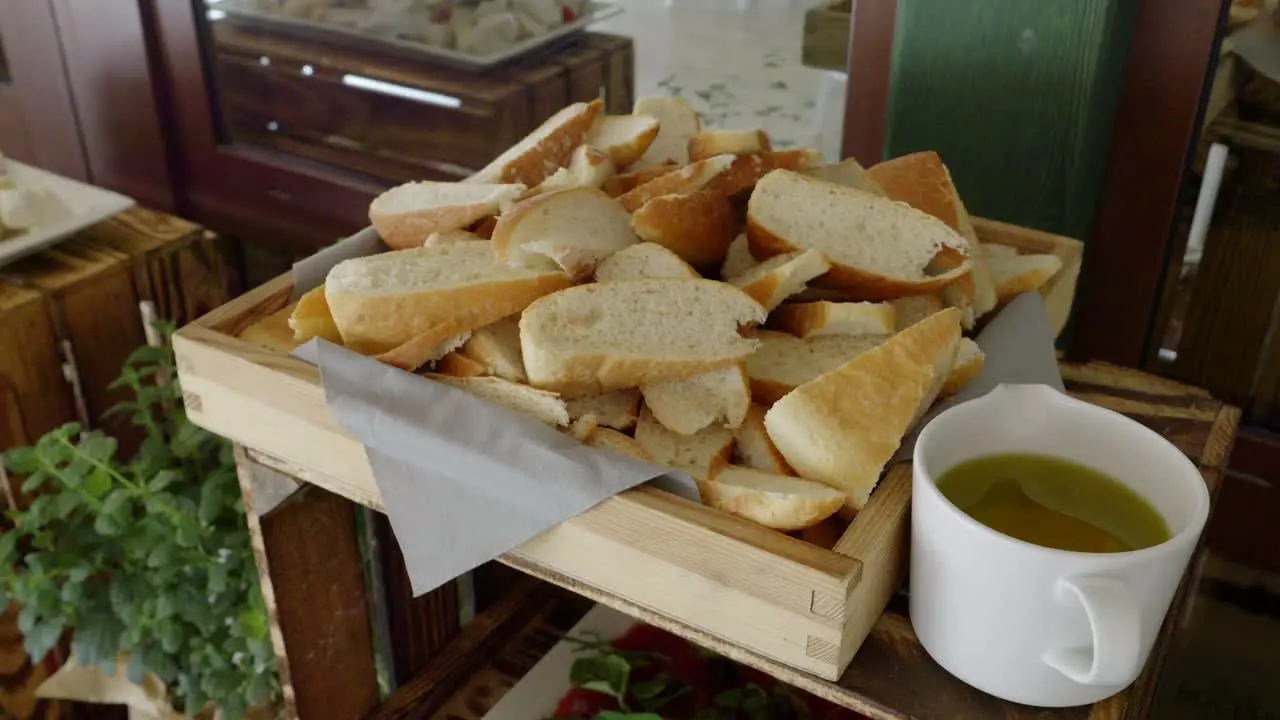 A rustic table made from a wooden crate on which there are slices of bread