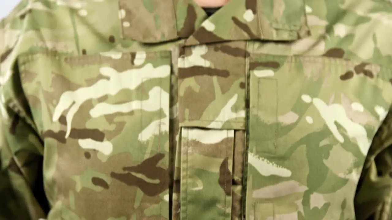 Close-up of soldier holding dairy on white background