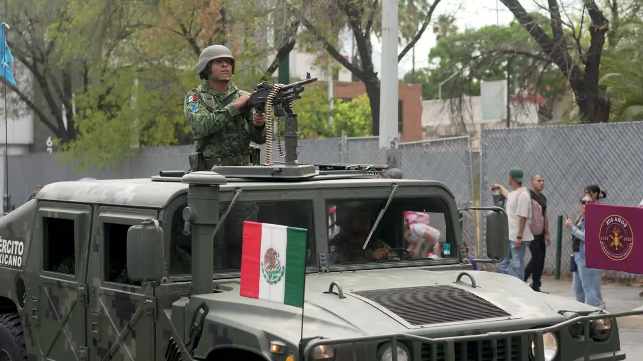 Military personnel of mexican army driving humwee at independence day parade