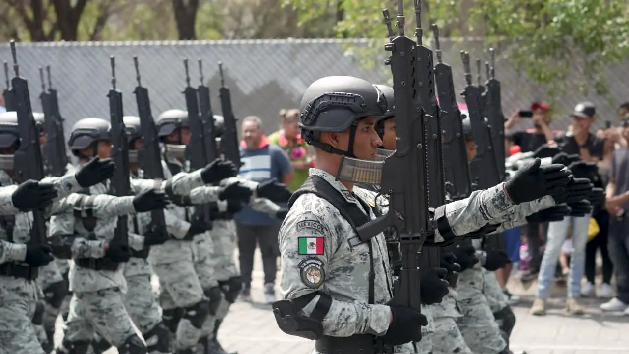 Heavy armed mexican soldiers are marching during parade of Mexican Independence Day