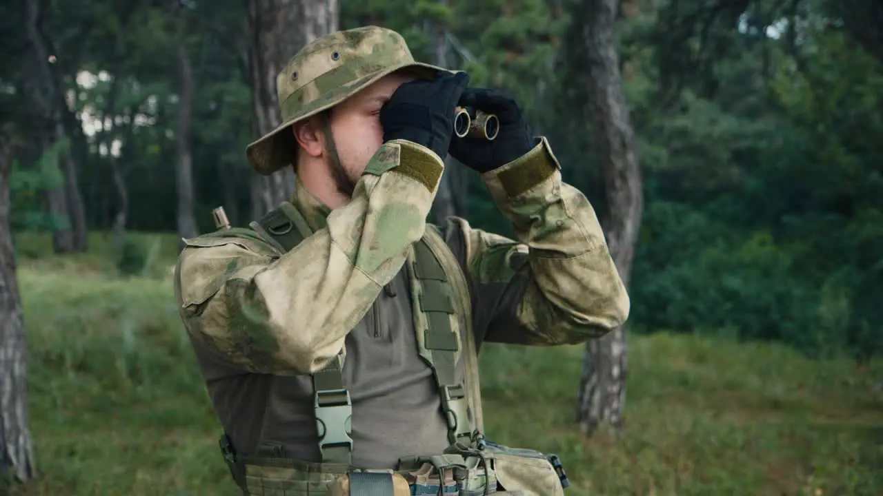 A soldier looks through binoculars 1