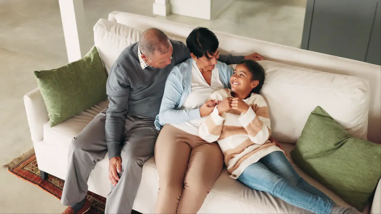 Girl relax and grandparents talking on the sofa