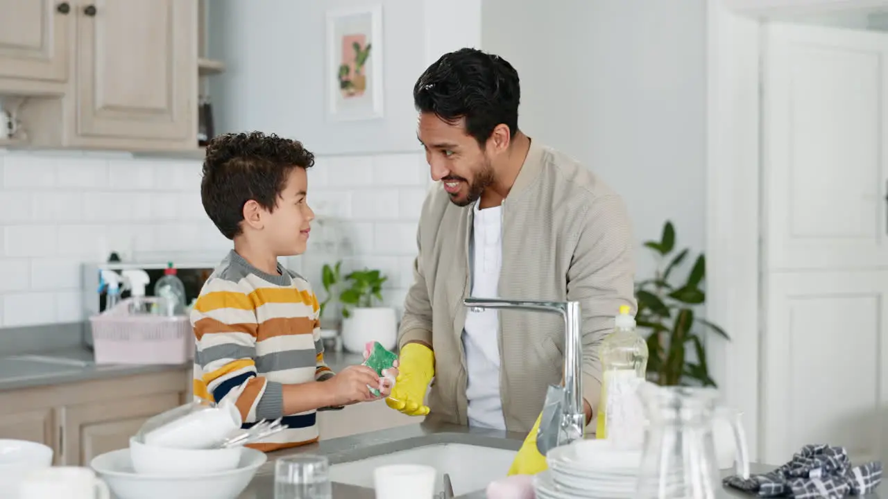 Dad washing dishes teaching kid