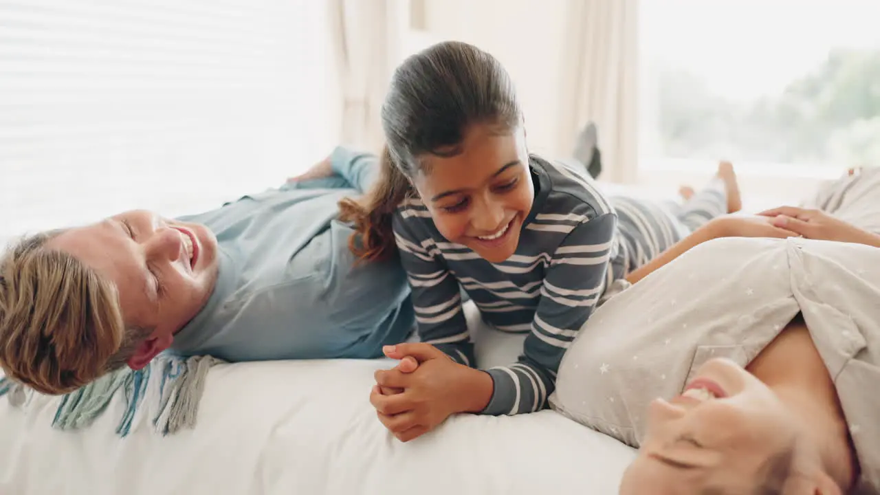 Happy family bed and kid playing in a bedroom