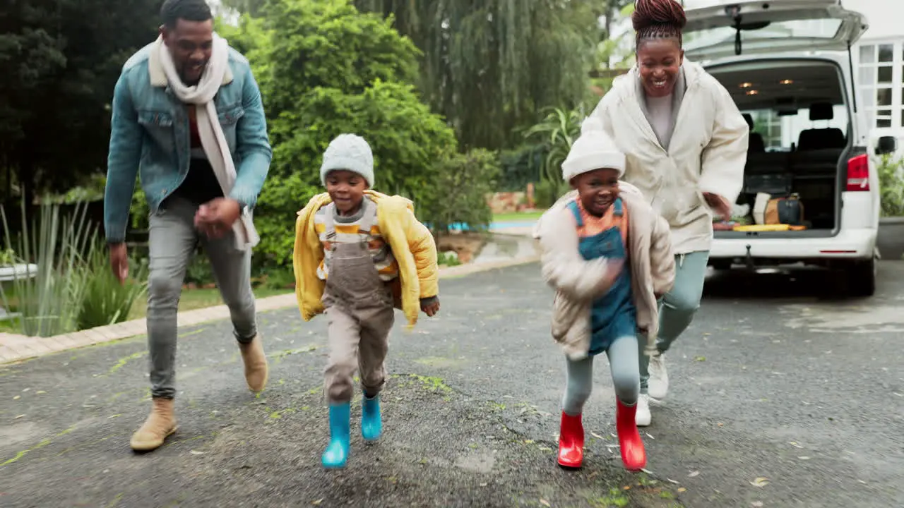 Running happy and black family in a home driveway