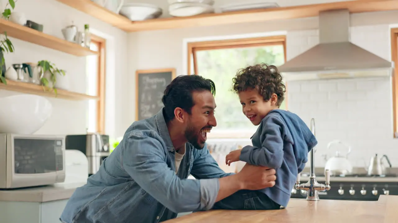 High five dad and kid playing in the kitchen