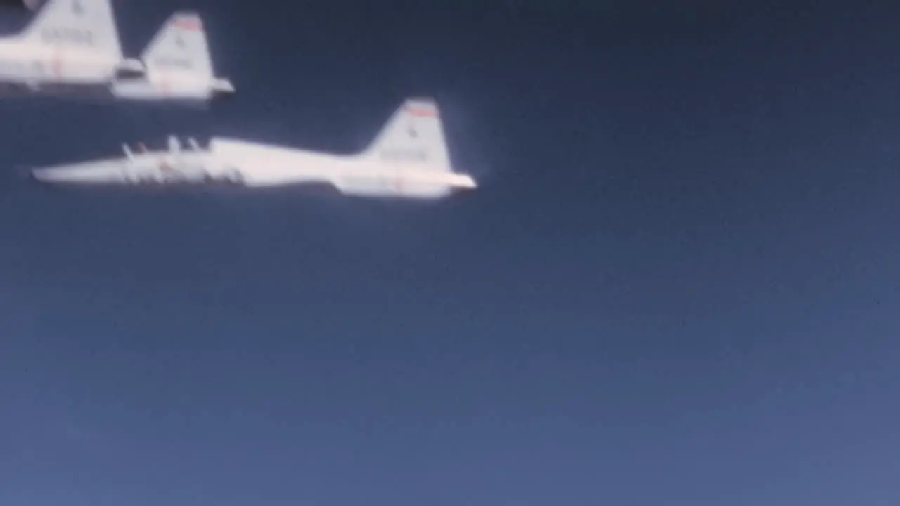 1960s USAF T-38 Talon Jet Planes Flight in Formation in Blue Sky Cockpit POV