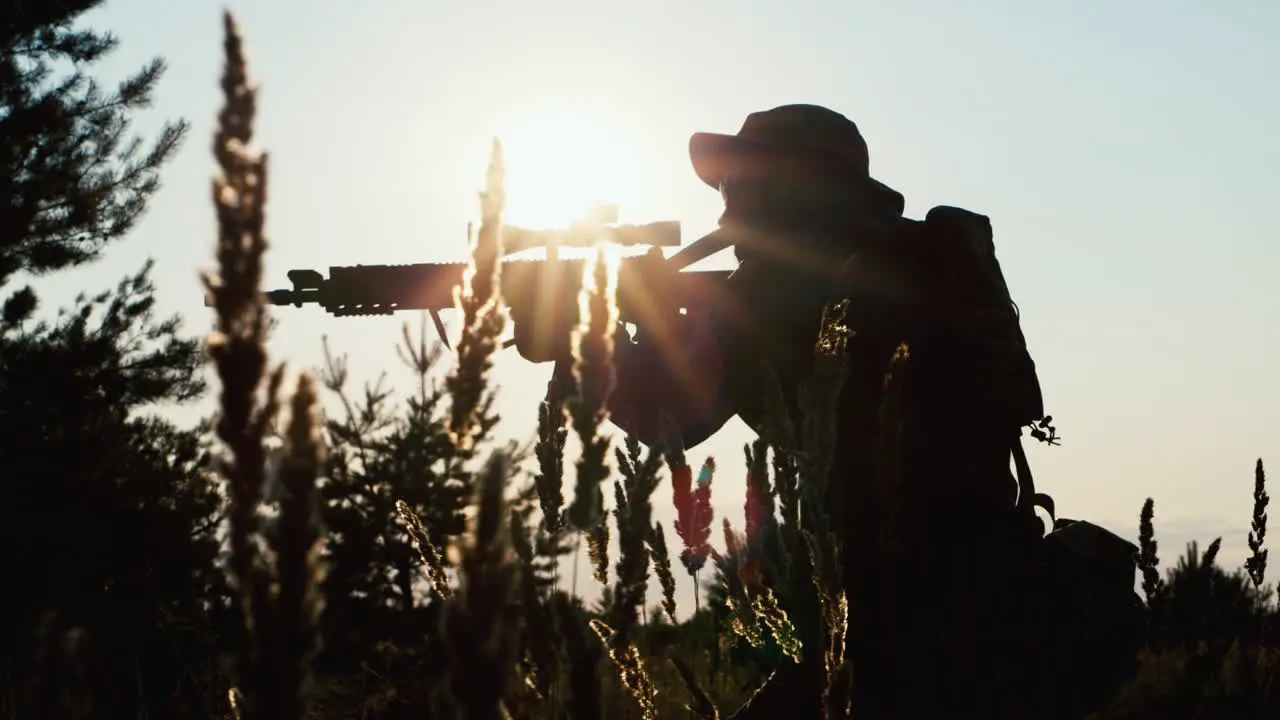 Silhouette of a sniper aiming with a rifle