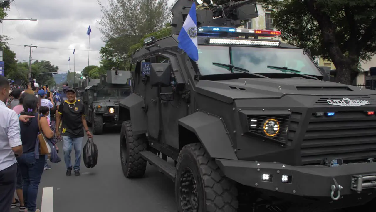 Military armored vehicles parade along the streets of the city of San Salvador during the country's independence day celebration