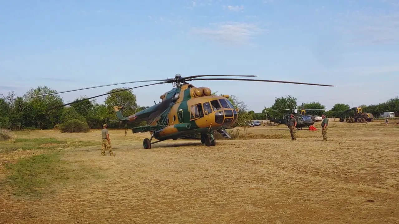 Army chopper preparing for take off in field