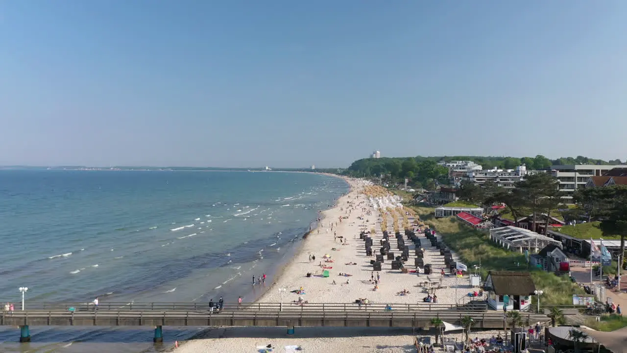 Scharbeutz beautiful aerial view of shoreline beach with people sunbathing enjoying Baltic sea forward Germany sunny day