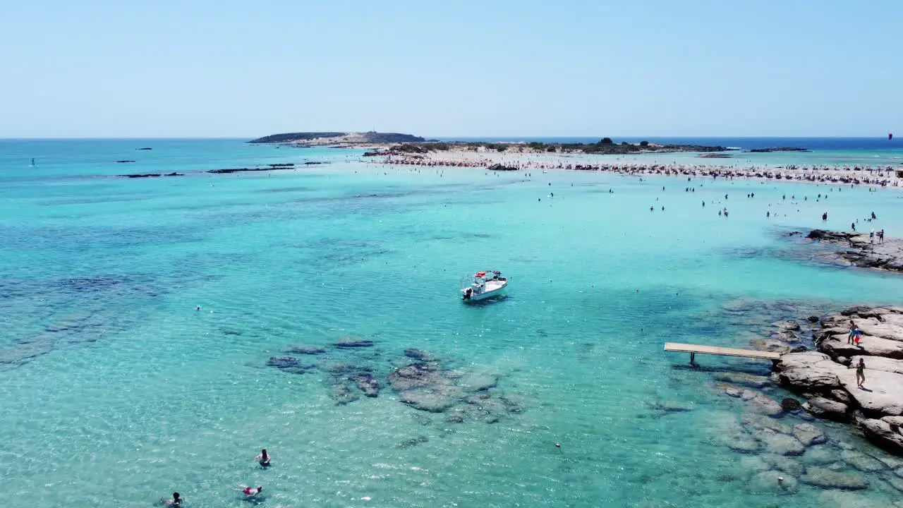 Tourists swimming and enjoying clear blue waters of Elafonissi beach Crete