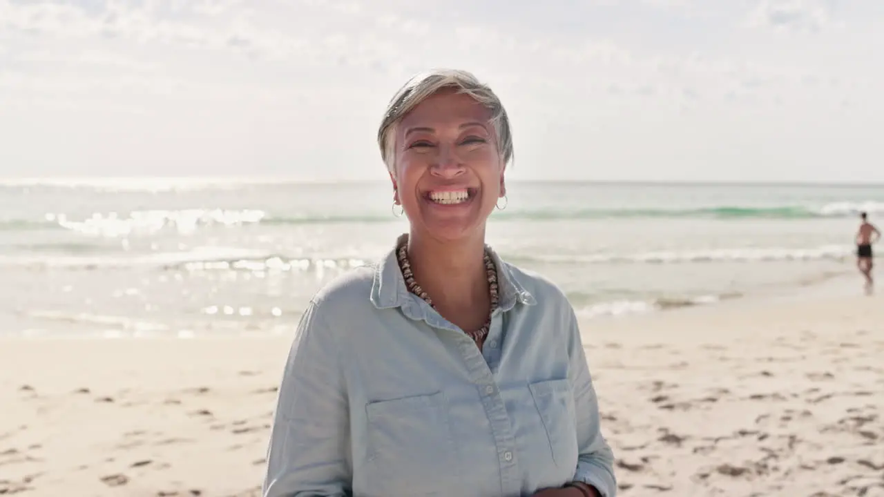 Happy face and elderly woman at a beach