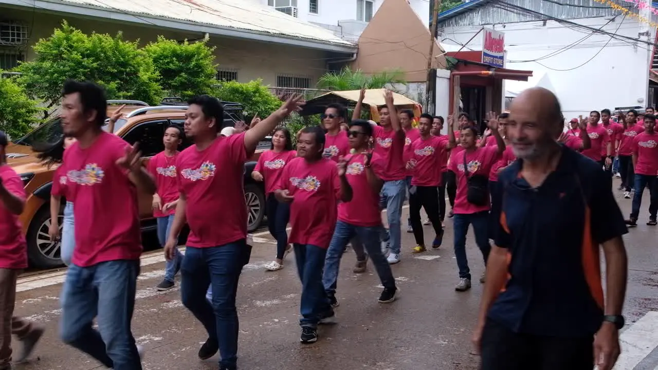 Crowds of Filipino people singing and dancing during Pintados Kasadyaan festival celebrations in Coron Town in Palawan Philippines Southeast Asia