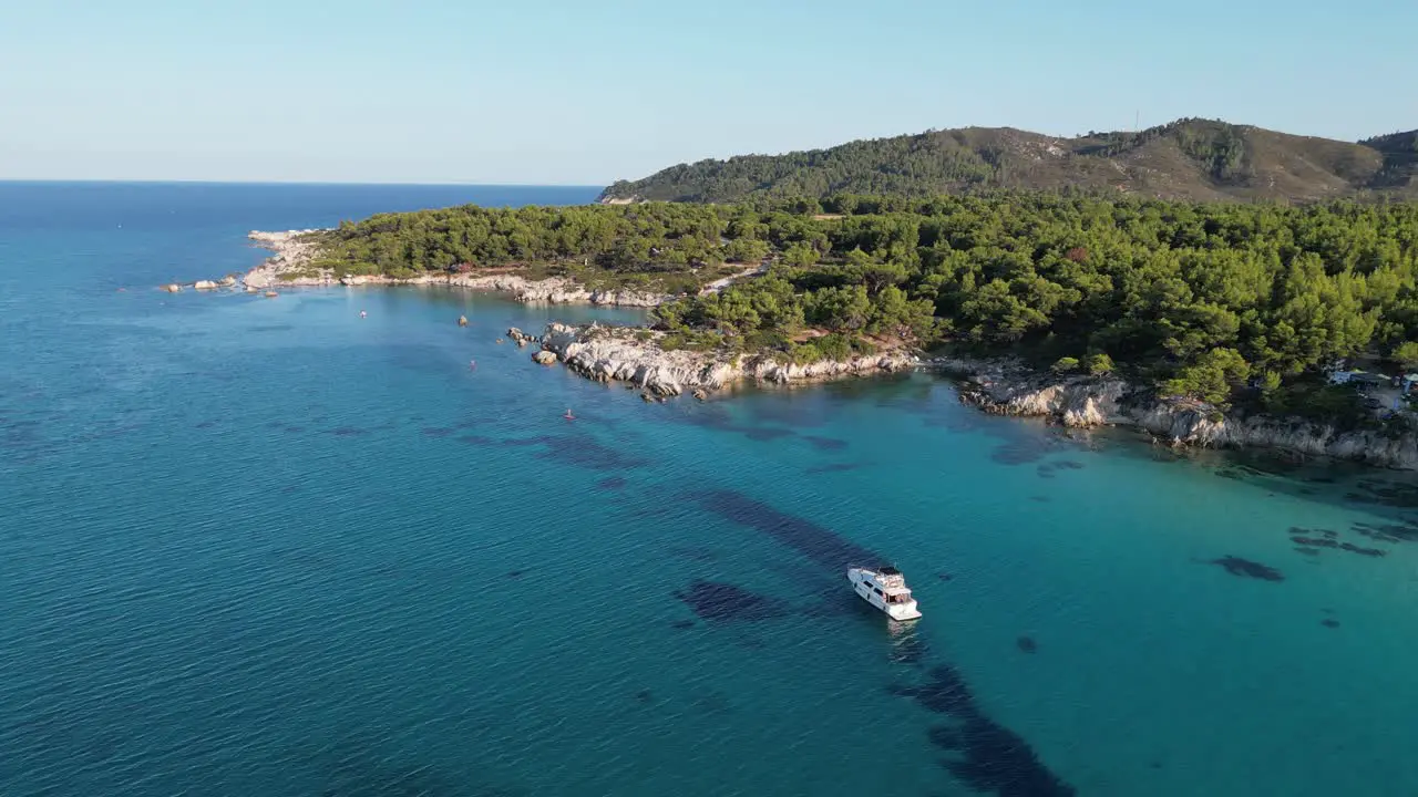 Boat anchored along Halkidiki Coast in Sithonia Greece Aerial 4k Circling