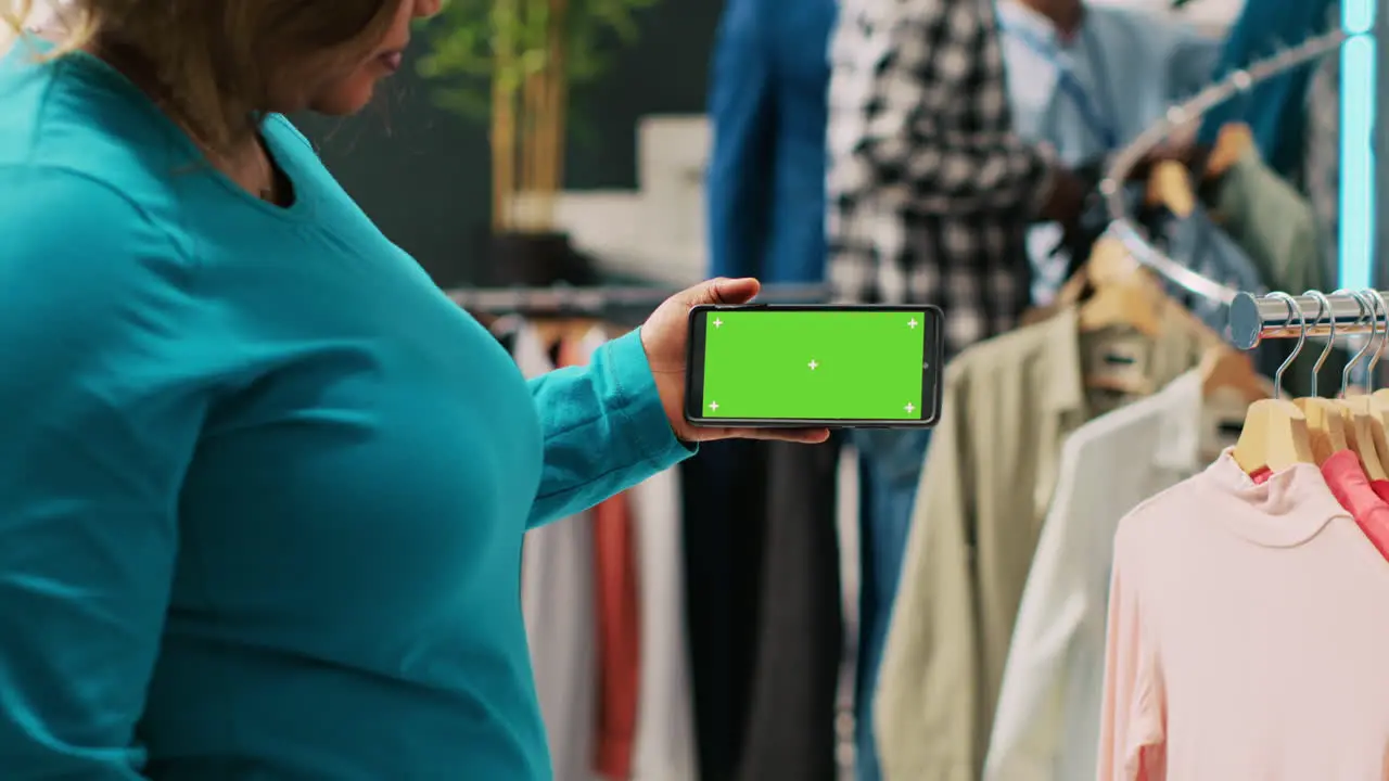 Woman analyzing phone with greenscreen