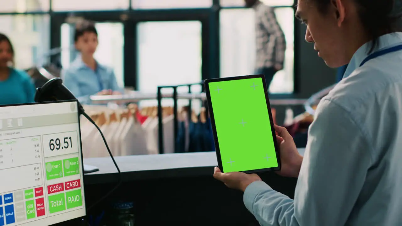 Worker looking at green screen tablet