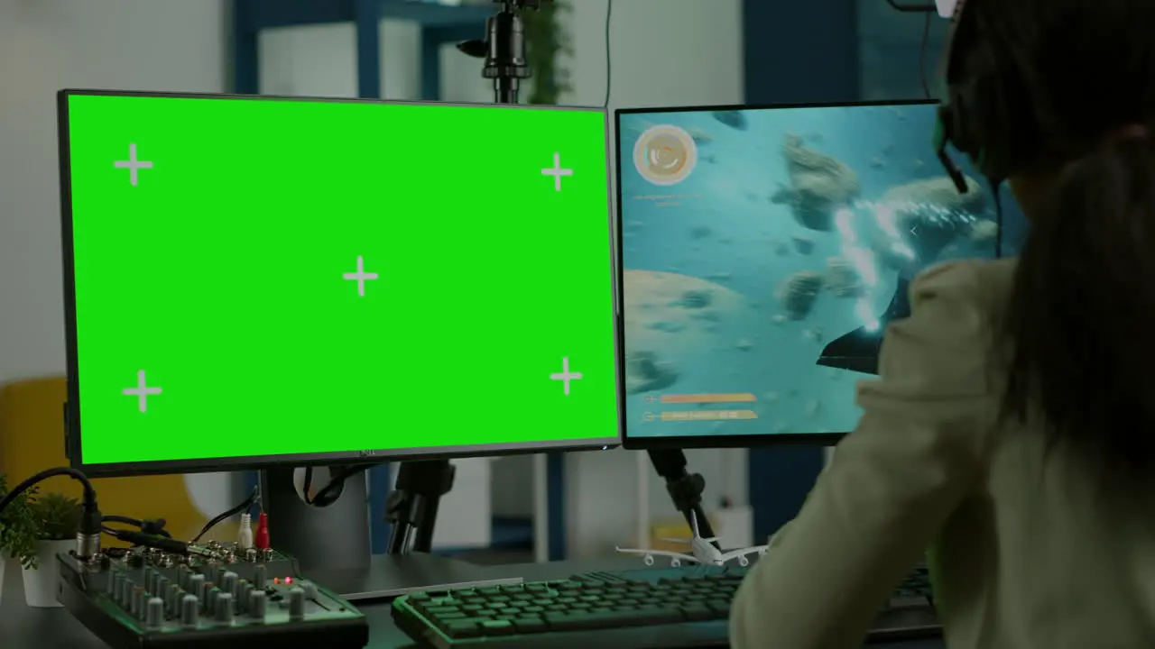 Black woman gamer streaming with chroma key display