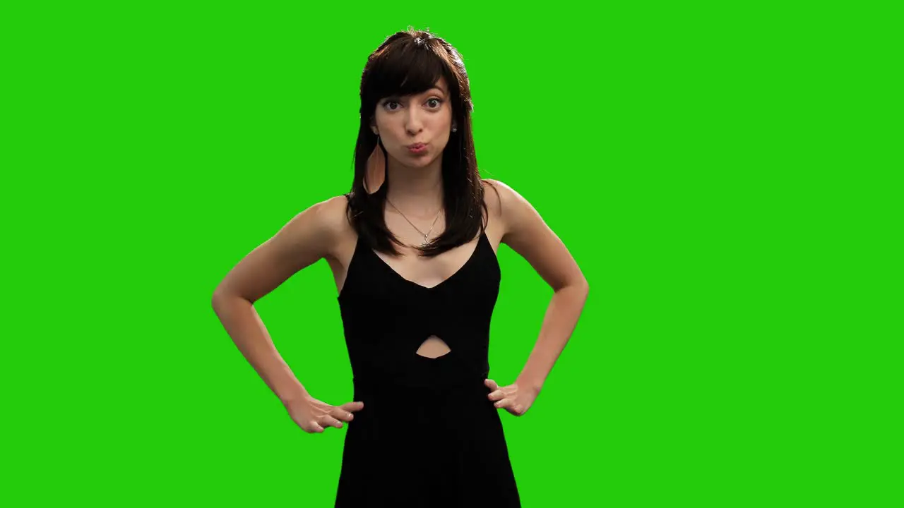 Cute Caucasian girl in black dress surprised on green screen