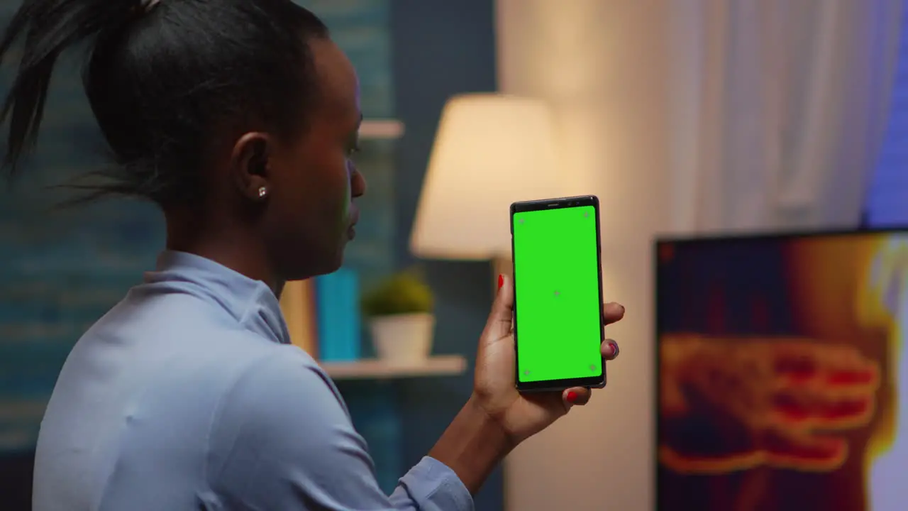 Housewife holding smartphone with chroma screen