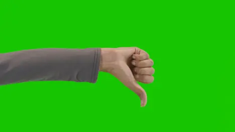 Studio Close Up Shot Of Woman Giving Thumbs Down Sign Against Green Screen 1