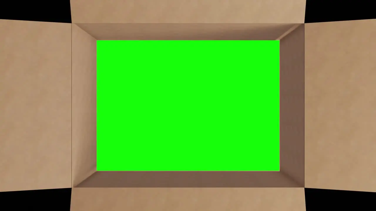 Overhead of green screen in brown cardboard box with lid closing on black background