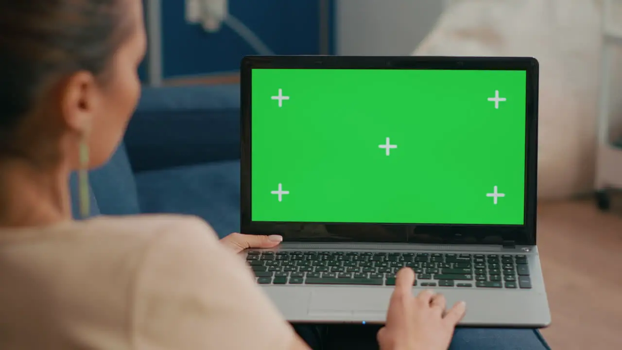 Close up of freelencer using laptop computer with mock up green screen chroma key display